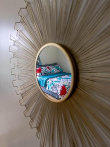 a mirror on a wall with a bed in it at Jhezzstuffs staycation in Iloilo City