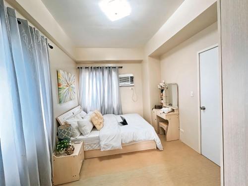 a bedroom with a bed and a desk in it at Iloilo Home Sweet Home in Iloilo City
