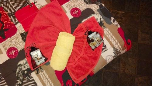 a red napkin with a piece of bread on a table at Devocean Eco Adventure Lodge in Ponta do Ouro