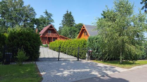 a house with a fence in front of it at Domek Letniskowy na Wyłączność - Łaszka in Łaszka