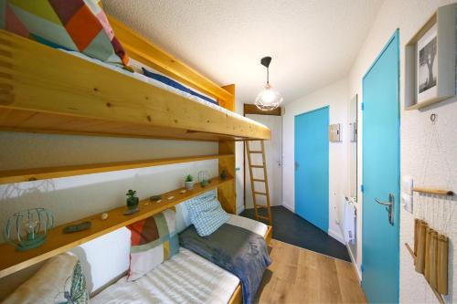 a room with a bunk bed and a couch at La Brise de Donville - A 300m de la plage in Donville-les-Bains