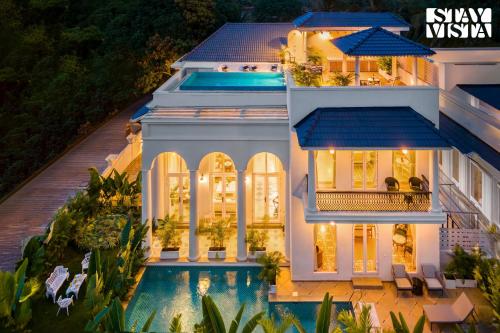 an aerial view of a house with a swimming pool at StayVista at Casa Armeh - Pool, BBQ in Siolim