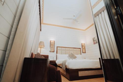 a hotel room with a bed and a mirror at Sinon Baga Retreat in Baga