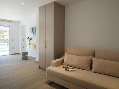 a living room with a couch with a book on it at Golden Luxury Suites in Balíon