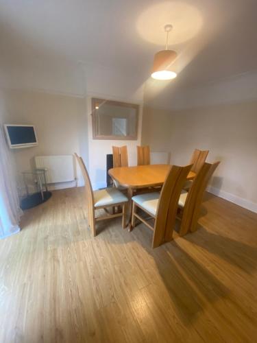 a dining room with a wooden table and chairs at Lovely 3 bed house in Crosby in Crosby