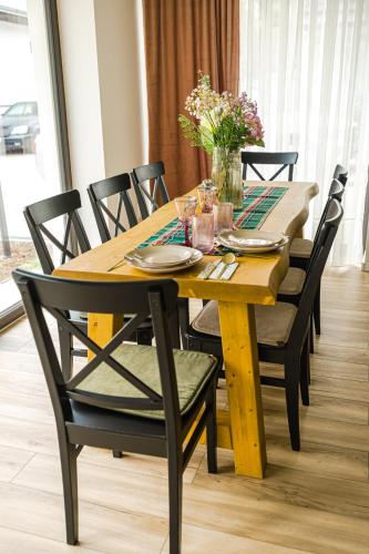 a wooden table with chairs and a dining room at IoanaGuestHouse in Turda