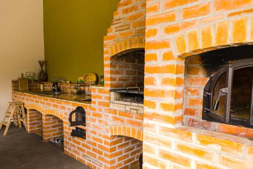 a brick fireplace in a kitchen with a counter top at IoanaGuestHouse in Turda