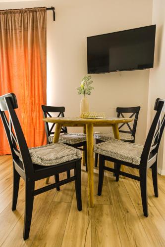 a dining room with a table and two chairs at IoanaGuestHouse in Turda