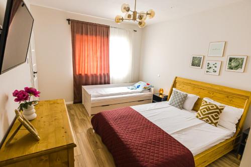 a bedroom with a bed and a table and a window at IoanaGuestHouse in Turda