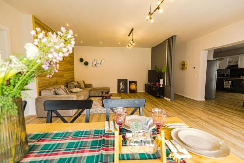 a dining room and living room with a table at IoanaGuestHouse in Turda