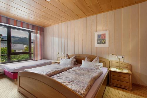 a bedroom with two beds and a window at Haus Schönblick in Willingen