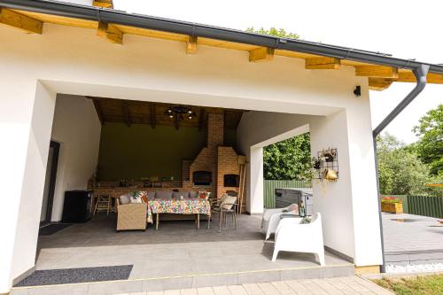 a patio with a table and chairs on it at IoanaGuestHouse in Turda