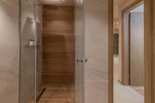 a shower with a glass door in a bathroom at Ionian Plaza Hotel & Spa in Argostoli