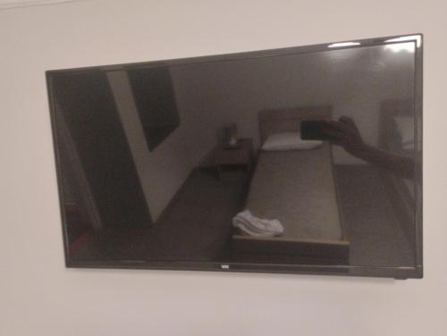 a mirror on a wall with a person taking a picture at MTX Tbilisi in Tbilisi City