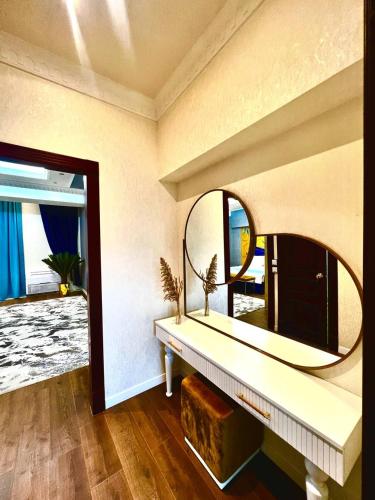 a room with a large mirror and a table at Antalya Grand Palace Hotel in Urganch