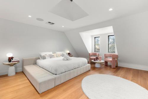 a white bedroom with a bed and a couch at Luxurious 3-Story Terrace in Potts Point in Sydney