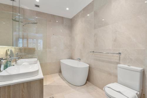 a bathroom with a toilet and a sink at Luxurious 3-Story Terrace in Potts Point in Sydney