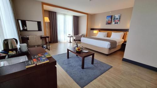 a hotel room with a bed and a table at Port Bosphorus Hotel in Istanbul
