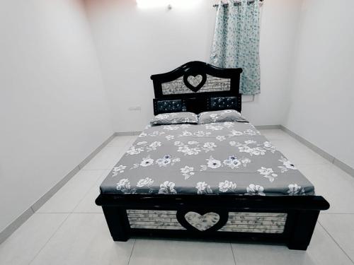 a bed sitting in a room with a bed sidx sidx sidx at Serene Sanctuary in Hyderabad