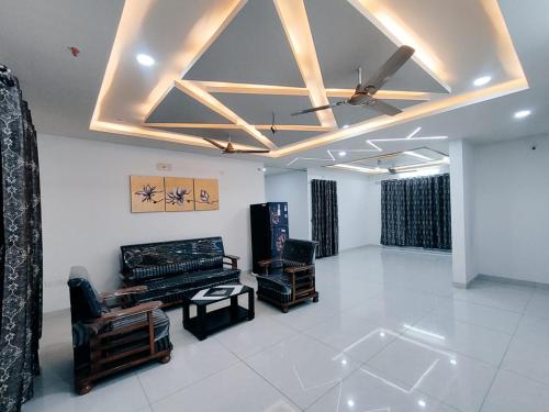 a living room with a ceiling fan and a room with white floors at Serene Sanctuary in Hyderabad