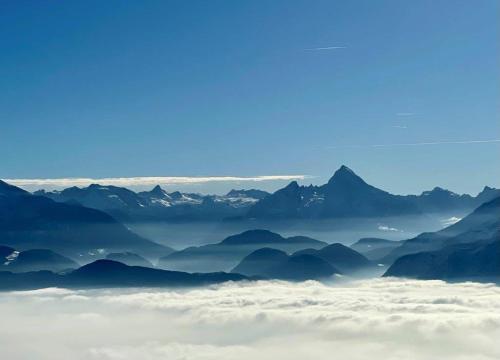a view of a mountain range from above the clouds at Römer Appartement mit sonniger Terrasse in Bad Reichenhall