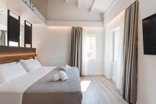 a hotel room with a bed and a window at Kantoni Suites in Corfu Town