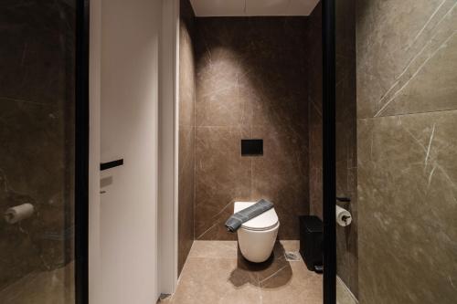 a bathroom with a toilet and a shower at Kantoni Suites in Corfu Town
