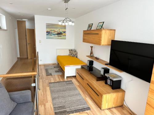 a living room with a large flat screen tv at Zur Düne Warnemünde in Warnemünde