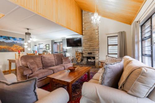 a living room with couches and a table at Misty peaks Cloudlands in Bergview