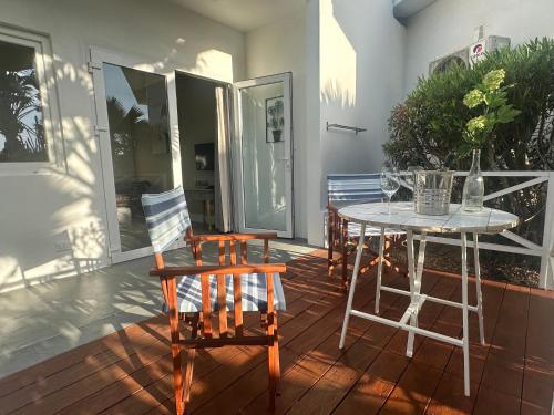 a patio with a table and chairs on a porch at The Rocks Residence, apartment 1 of total 2 in Paradera