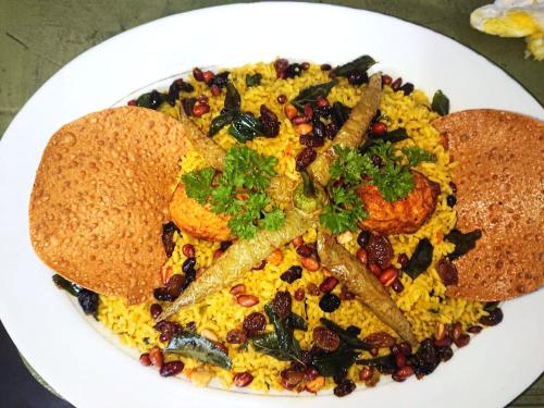 a plate of food on a white plate at Athyantha Resort in Anuradhapura