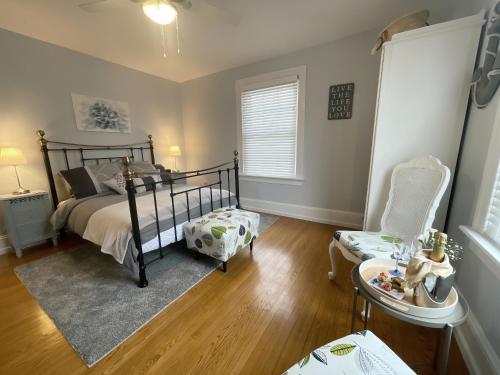 a bedroom with a bed and a chair at The Boardwalk Inn in Summerside