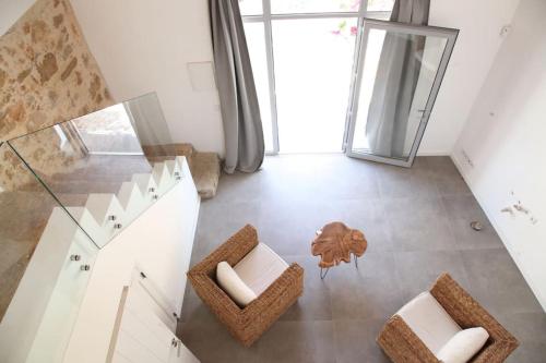 a living room with a glass table and chairs at Amazing apartment, Olhao with pool, beach close by in Olhão