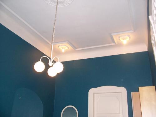 a bathroom with three lights hanging from the ceiling at Eden Apartment Budapest in Budapest