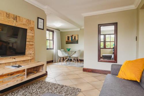 a living room with a large flat screen tv at Silver Guest Studio in George