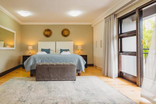 a bedroom with a bed and a large window at Silver Guest Studio in George