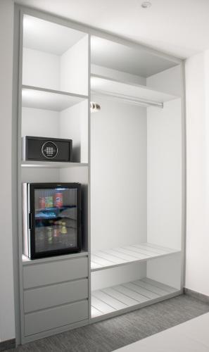 a closet with a tv and a mirror at Papavero Giallo B&B in Le Castella