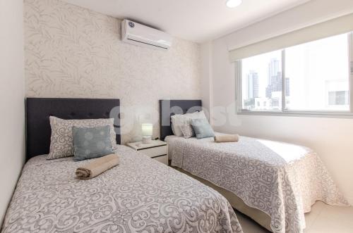 Postel nebo postele na pokoji v ubytování New-exclusive 2-bedroom Apt In Molas Lpez Area