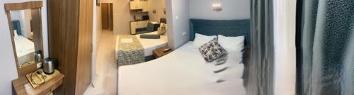 a bedroom with a bed with a blue head board at Riverland Suites Apart Hotel in Istanbul