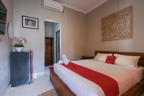 a bedroom with a large bed in a room at RedDoorz near Mertasari Beach 2 in Pesanggaran