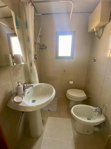 a bathroom with a sink and a toilet at Venice Nora's House in Mestre