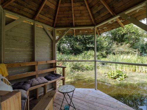 an inside view of a large wooden house with a porch at The Foxes Den Shepherds Hut in Bristol