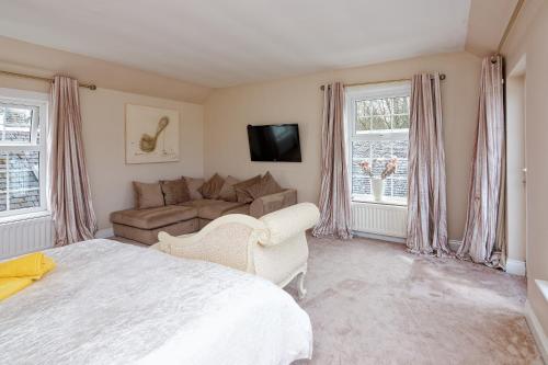 a bedroom with a bed and a couch at Brig o Doon 2 in Ayr