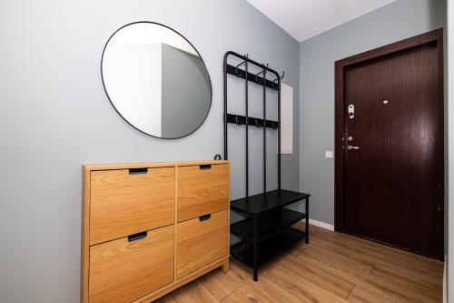 a room with a dresser and a mirror on the wall at ᴄᴏʜᴏsᴛ I 2BD Apartment With Balcony in Mažeikiai