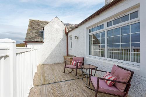a patio with chairs and a table on a balcony at Brig o Doon 2 in Ayr