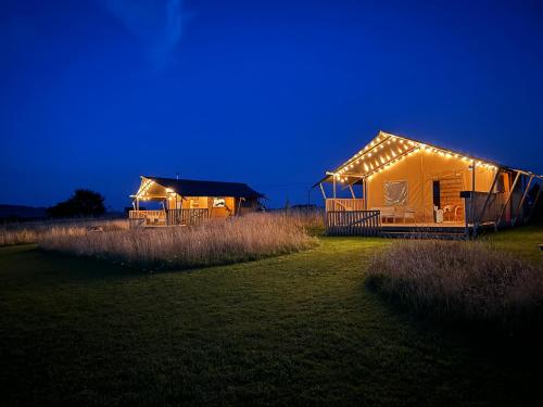 a large tent in a field at night at The Paddock in Bredon