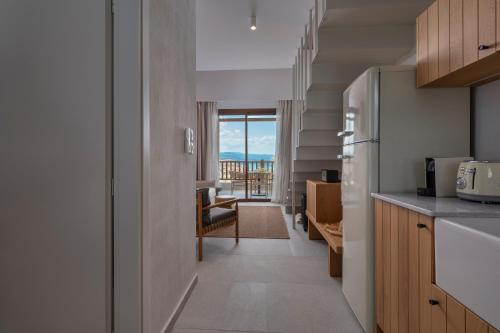 a kitchen with a view of the ocean from a room at Anima Residence in Nea Roda