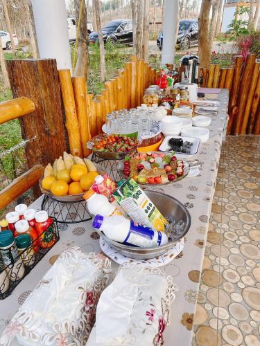 a long table with plates of food on it at One khaokho homestay in Khao Kho