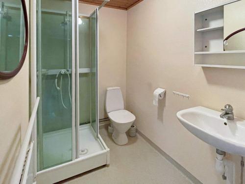a bathroom with a shower and a toilet and a sink at 4 star holiday home in SVÄNGSTA in Svängsta