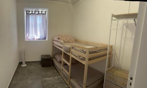 a room with two bunk beds and a window at Casa da alegria in Vieira de Leiria